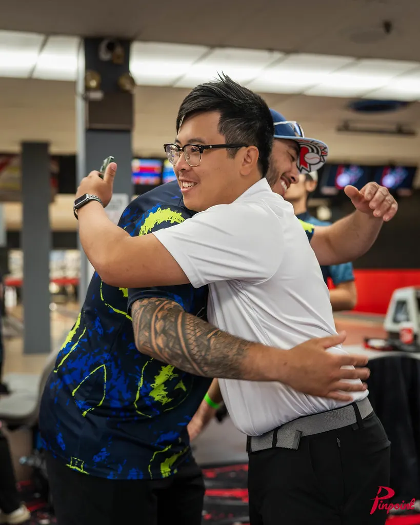 Two bowlers hug on the concourse at The Toronto Experience, 2025
