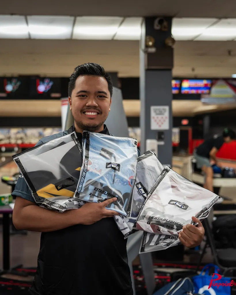 A bowler smiles with an armful of new jerseys at The Toronto Experience, 2025